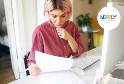 jeune femme consultant des documents devant son ordinateur