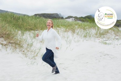 femme senior courant dans les dunes