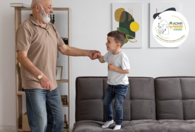 grand-père dansant avec son petits-fils debout sur le canapé